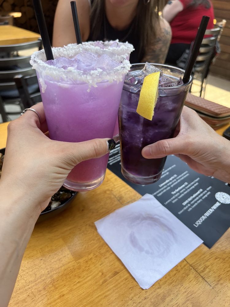 Clinking purple cocktails