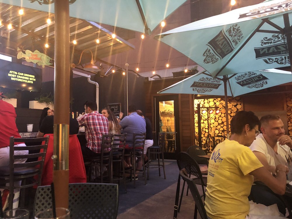 Social House Grand Rapids patio, guests dining under string lights
